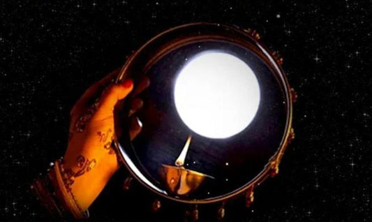 Women look at the Moon on Karwa Chauth Through a Sieve