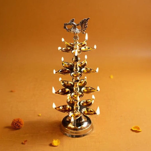 Brass oil lamp with multiple oil lamps on an orange background