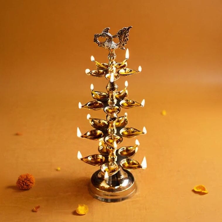 Brass oil lamp with multiple oil lamps on an orange background