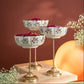 Decorative tiered stand with small bowls on a wooden surface against a warm brown background